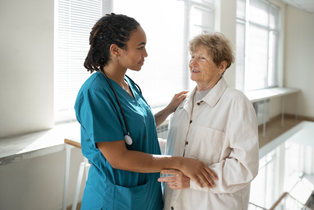 A Certified Nursing Assistant talking with an elderly female