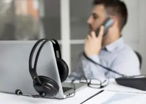 Man at his desk, on the phone