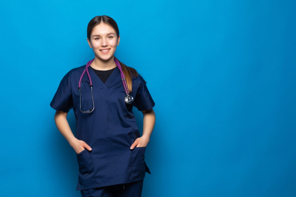 A Licensed Practical Nurse leaning agains a blue wall