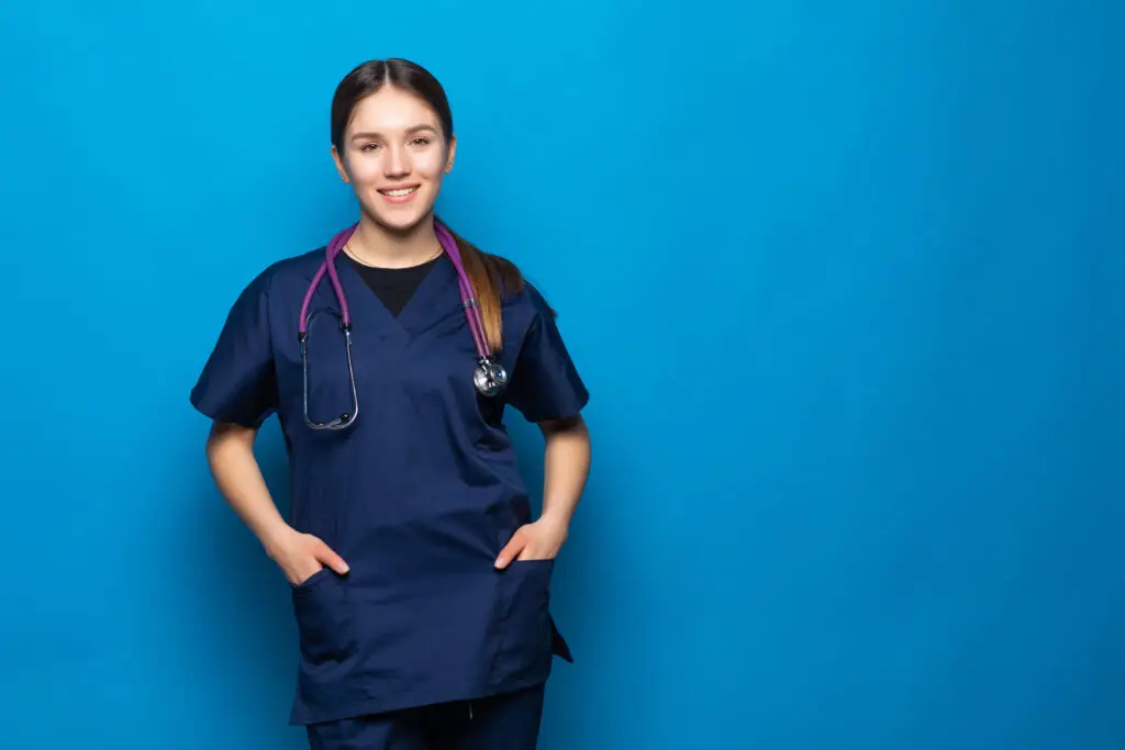 LPN standing in front of a navy blue backdrop smiling