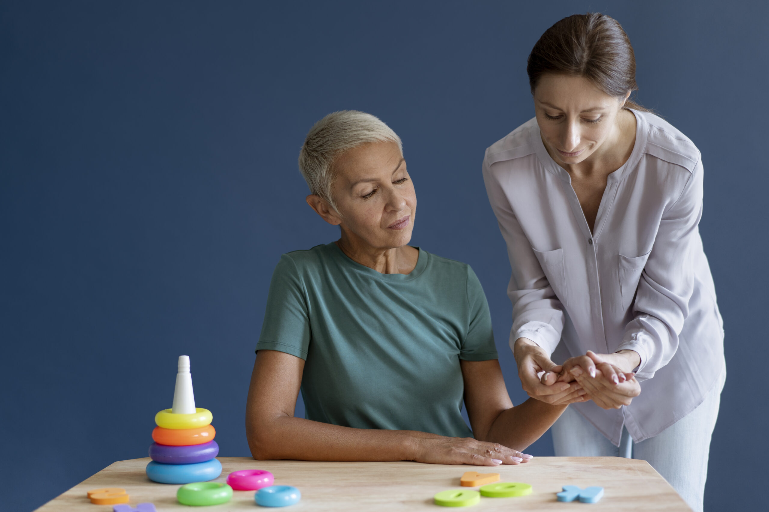 Occupational therapist working with a patient on her wrist injury